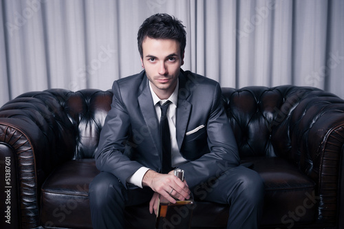 Photo: Worried Young Businessman with Drinking Problems Worried Young Businessman with Drinking Problems