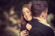 Photo: Love and affection between a young couple at the park Love and affection between a young couple at the park
