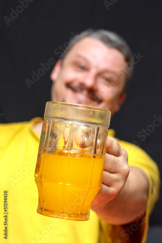 Photo: dark smiling man holding a glass of beer dark smiling man holding a glass of beer