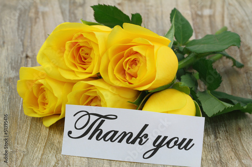 Photo: Thank you note with yellow bouquet on wooden surface Thank you note with yellow bouquet on wooden surface