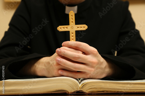 Photo: Priest reading from the holy bible, close up Priest reading from the holy bible, close up