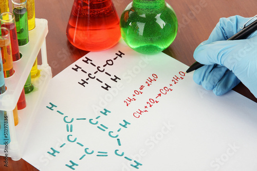 Photo: Hand scientist writing formulas Hand scientist writing formulas