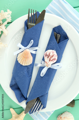 Photo: Marine table setting on color wooden background Marine table setting on color wooden background