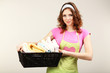 Housewife carrying laundry basket full of clothing