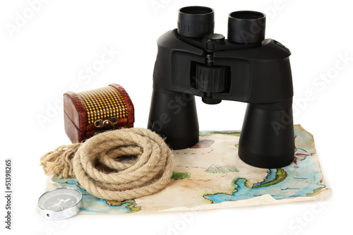 Photo: Black modern binoculars with map of adventure isolated on white Black modern binoculars with map of adventure isolated on white