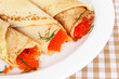 Foto: Delicious pancakes with red caviar on table close-up Delicious pancakes with red caviar on table close-up