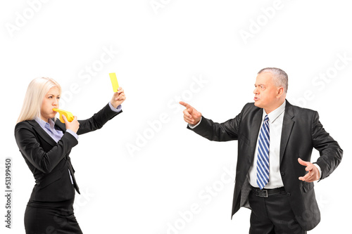 Photo: Professional woman showing a yellow card to her boss Professional woman showing a yellow card to her boss