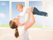 happy family. Mother throws up baby, playing