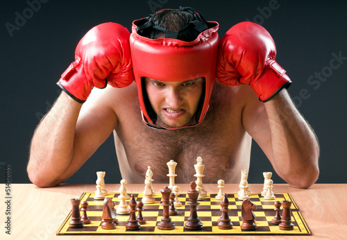 Photo: Boxer stuggling with chess game Boxer stuggling with chess game