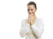 Photo: Young woman looking surprised against white background Young woman looking surprised against white background