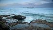 Wave breaking on the rocks of the ocean coastline