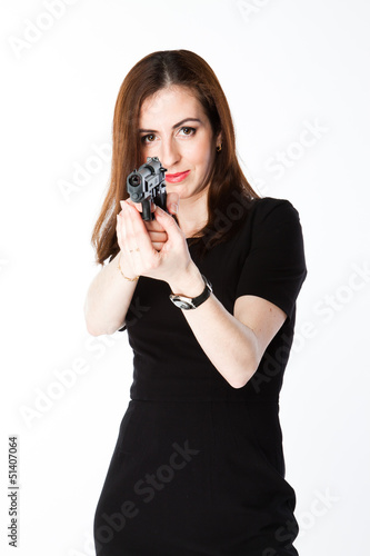Photo: Young and beautiful woman with a gun Young and beautiful woman with a gun