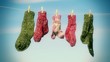 Three pairs of woolen socks hanging on rope