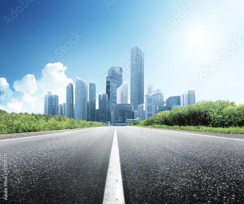 Photo: Asphalt road and modern city Asphalt road and modern city