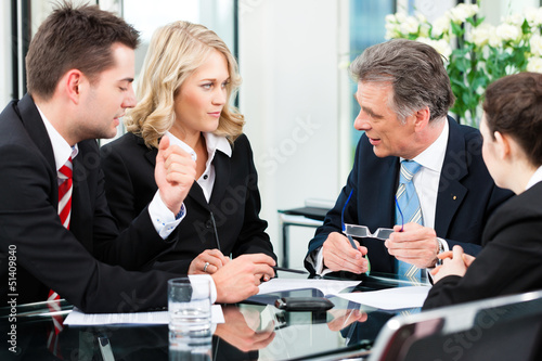 Photo: Business people - meeting in an office Business people - meeting in an office
