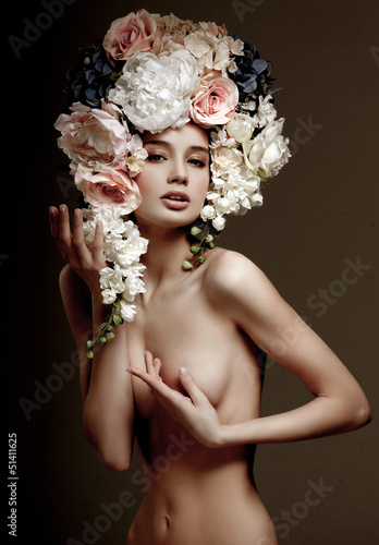 Photo: fashion model with large hairstyle and flowers in her hair. fashion model with large hairstyle and flowers in her hair.