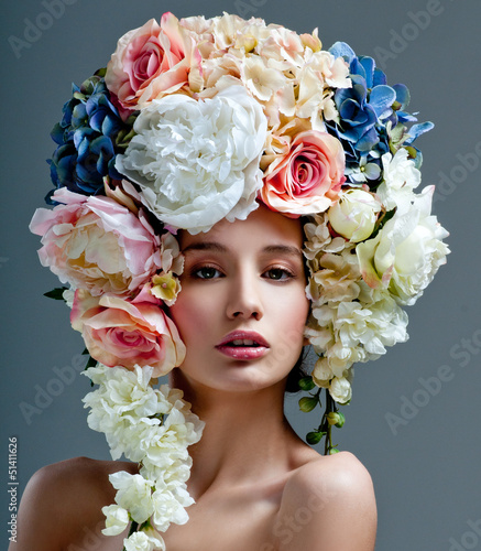 Photo: fashion model with large hairstyle and flowers in her hair. fashion model with large hairstyle and flowers in her hair.