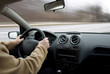 Man driving car on road, blurred motion
