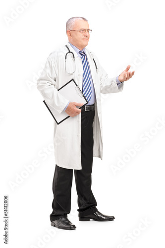 Photo: Full length portrait of a male medical doctor in a uniform expla Full length portrait of a male medical doctor in a uniform expla