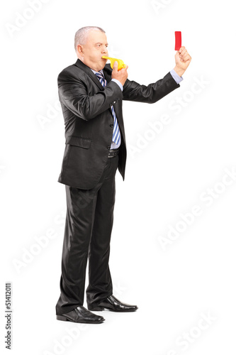 Photo: Full length portrait of a mature businessman blowing a whistle a Full length portrait of a mature businessman blowing a whistle a