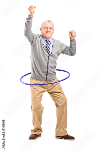 Photo: Full length portrait of a mature gentleman dancing with a hula h Full length portrait of a mature gentleman dancing with a hula h