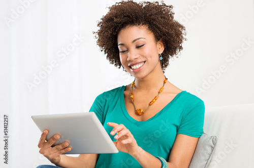 Photo: African Woman Looking At Digital Tablet African Woman Looking At Digital Tablet
