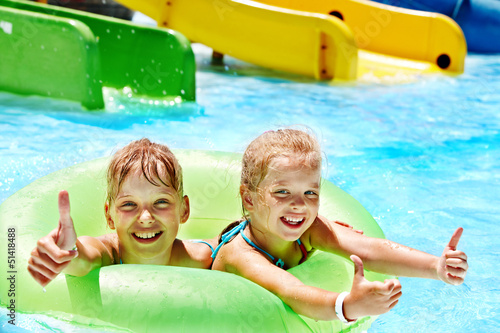 Photo: Children sitting on inflatable ring. Children sitting on inflatable ring.