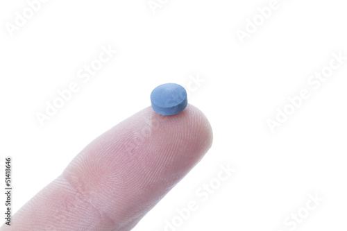 Photo: a blue pill balancing on the tip of a human finger a blue pill balancing on the tip of a human finger