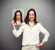 happy woman holding her sad picture