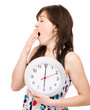 Young woman is holding big clock