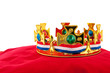 Golden crown on velvet pillow with Dutch flag