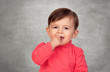 Adorable baby girl sucking her mouths