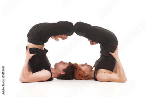 Photo: Two women and one men practicing yoga Two women and one men practicing yoga