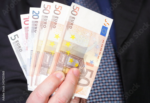 Photo: Euro banknotes in male hand Euro banknotes in male hand