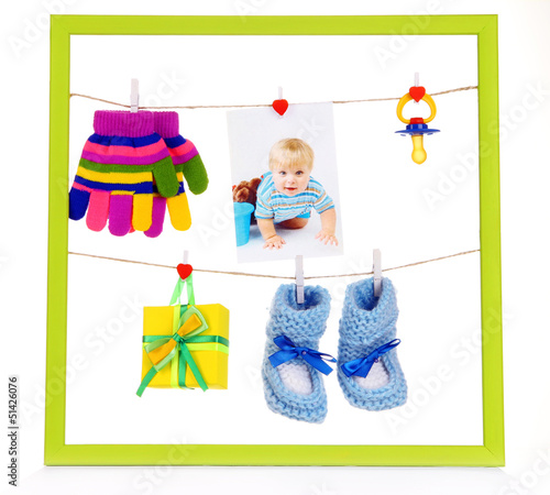 Photo: Colorful frame with different things on rope isolated on white Colorful frame with different things on rope isolated on white
