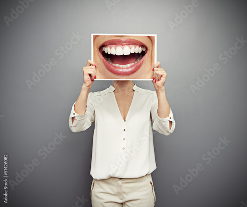 Photo: woman holding picture with big smile woman holding picture with big smile