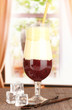 Delicious fruit smoothie on window background