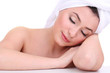 Beautiful young woman with towel on her head isolated on white