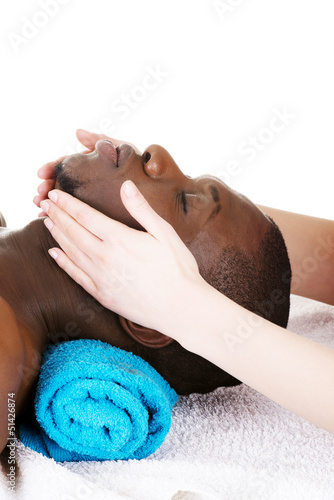 Photo: Black man recaiving head massage at spa. Black man recaiving head massage at spa.