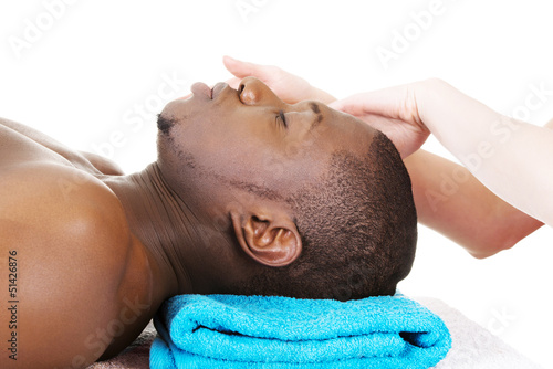 Photo: Black man recaiving head massage at spa. Black man recaiving head massage at spa.