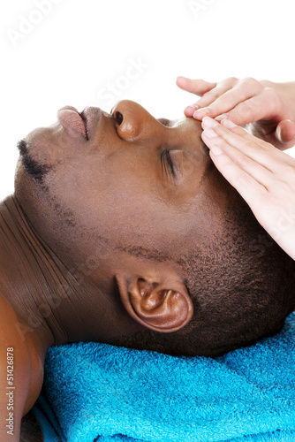 Photo: Black man recaiving head massage at spa. Black man recaiving head massage at spa.