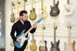 Attractive men playing a electric guitar