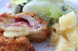 Chicken cordon bleu on black background