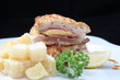 Chicken cordon bleu on black background