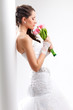 Photo: beautiful bride standing near white column beautiful bride standing near white column