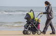 Photo: Madre con cochecito bebe por la playa Madre con cochecito bebe por la playa