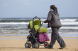 Photo: Madre con cochecito bebe por la playa Madre con cochecito bebe por la playa