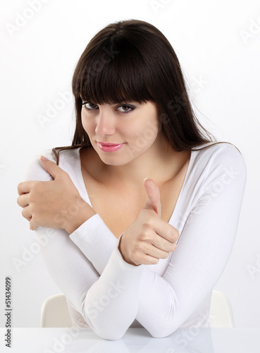 Photo: woman in home office showing his thumb, okay, sure, woman in home office showing his thumb, okay, sure,