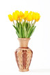 Yellow tulips in a wicker vase on a white background.