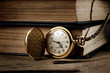 vintage pocket clock and old books
